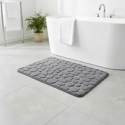 Tapis de bain gris galets dans une salle de bain moderne avec baignoire et plantes