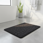 Tapis de bain noir galets dans une salle de bain moderne avec baignoire et plantes