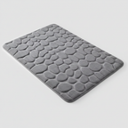Tapis de bain gris galets sur fond gris clair avec ombre élégante